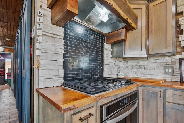 a kitchen with stainless steel appliances a refrigerator and a stove