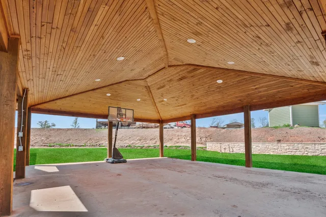 a building outdoor space with patio furniture and wooden floor