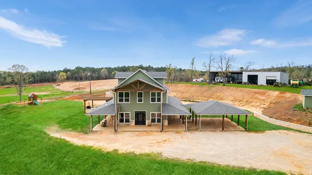 a view of a house with a yard and sitting area