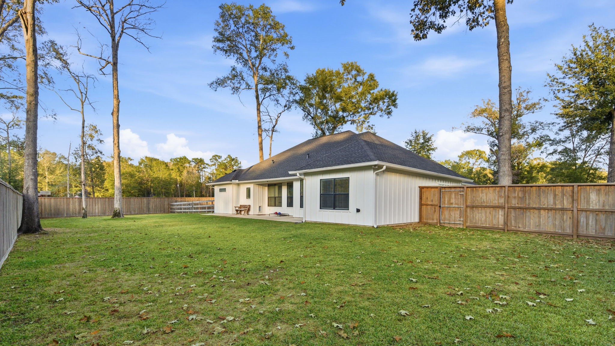 75 County Road 3669 North Splendora, TX 77372 - Photo 36 of 36 Fenced in back yard, concrete front and back patios have tongue & groove ceilings.