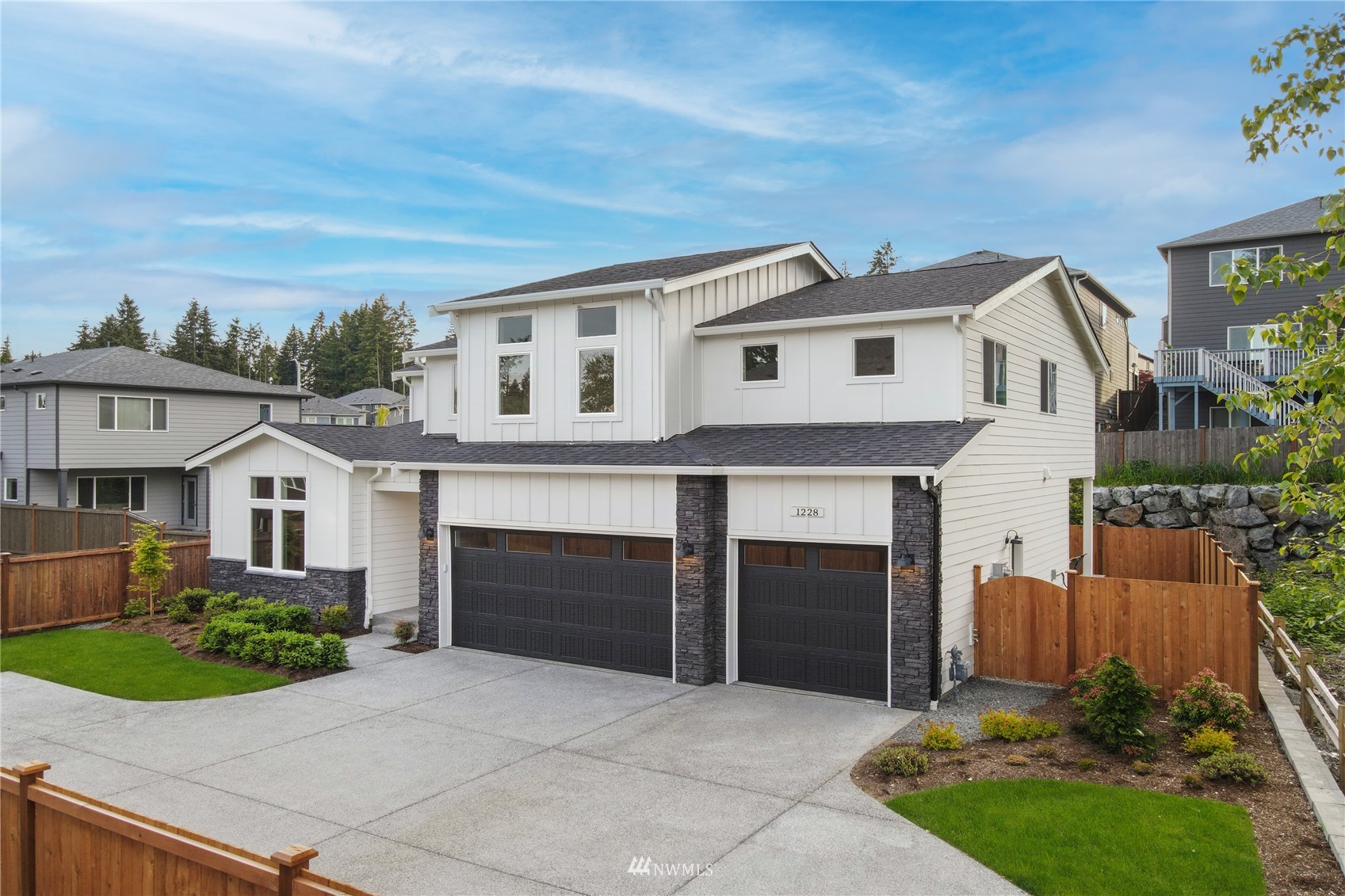 1228 197th Place Southeast Bothell, WA 98012 - Photo 1 of 34 a front view of a house with a garden
