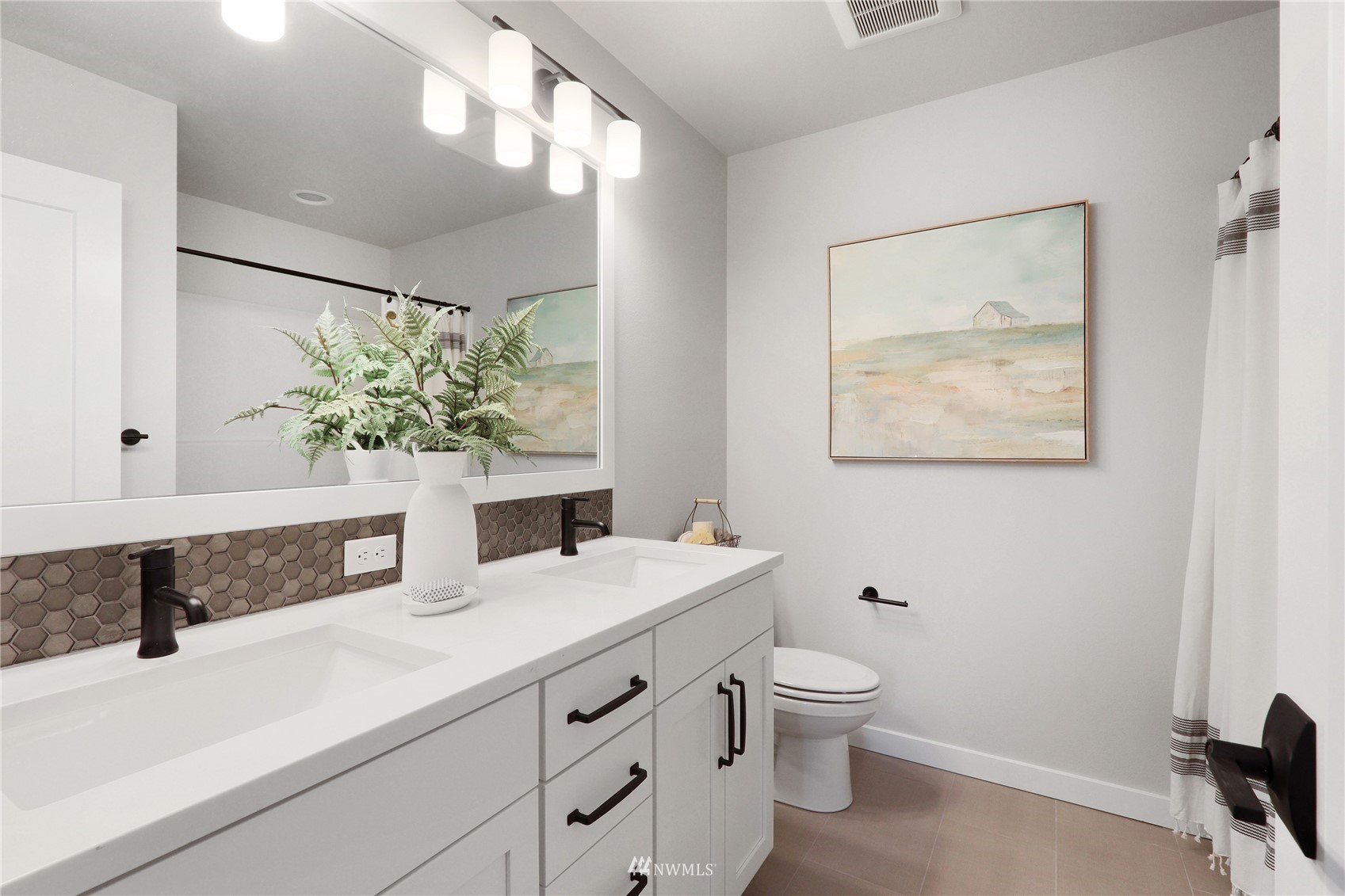 1228 197th Place Southeast Bothell, WA 98012 - Photo 25 of 34 a bathroom with a granite countertop sink a toilet and a large mirror