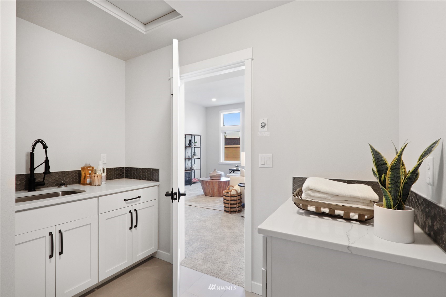 1228 197th Place Southeast Bothell, WA 98012 - Photo 29 of 34 a kitchen with a sink a counter space and a view of living room