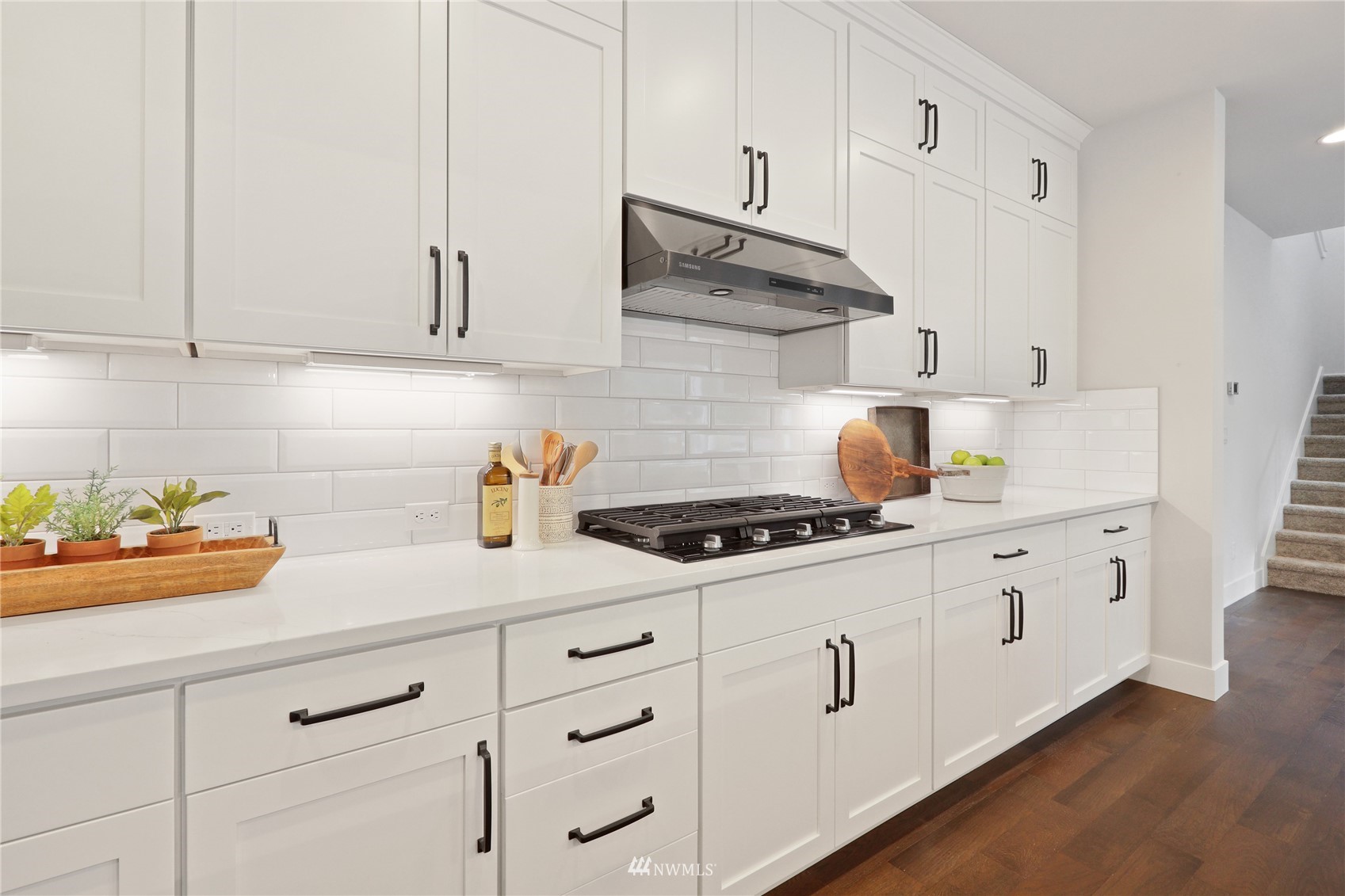 1228 197th Place Southeast Bothell, WA 98012 - Photo 6 of 34 a kitchen with white cabinets and white appliances