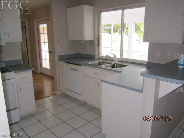 17533 Ingram Road Fort Myers, FL 33967 - Photo 6 of 9 a kitchen with a sink window and cabinets