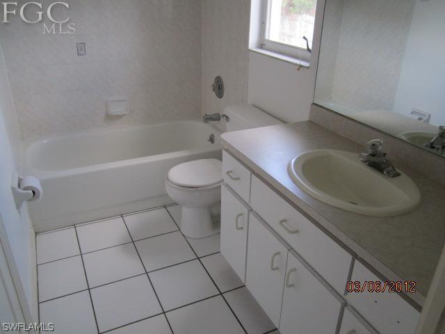 17533 Ingram Road Fort Myers, FL 33967 - Photo 7 of 9 a bathroom with a sink a toilet and window