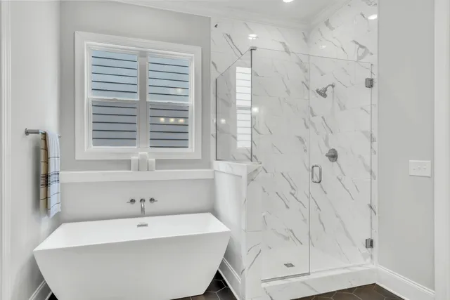 a bathroom with a double vanity sink a mirror and a bathtub