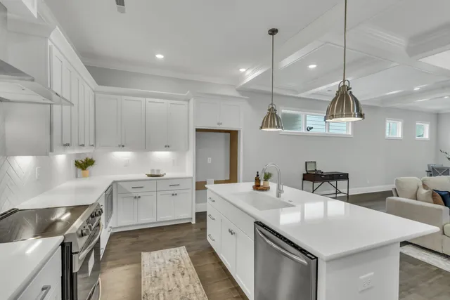 a kitchen with a sink a stove and chairs