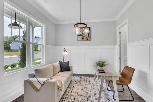 a living room with furniture and a chandelier