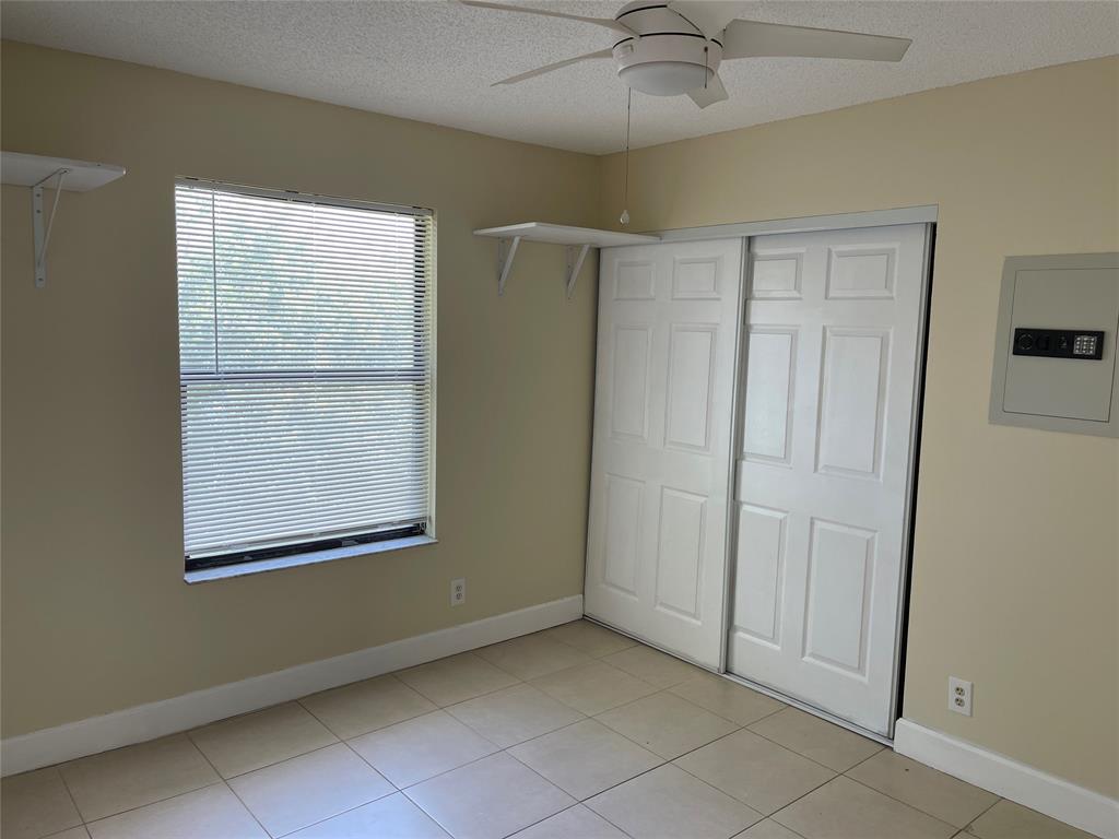 26 Crossings Circle, Unit G Boynton Beach, FL 33435 - Photo 11 of 14 an empty room with a window and a fan