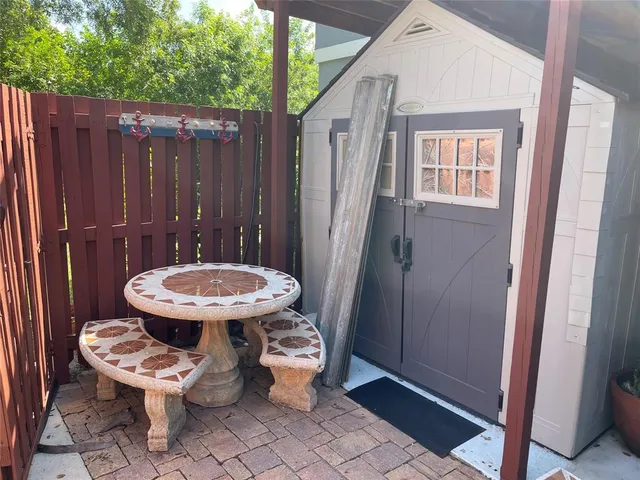 a view of a room with a chairs and wooden fence