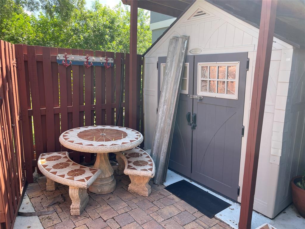 26 Crossings Circle, Unit G Boynton Beach, FL 33435 - Photo 13 of 14 a view of a room with a chairs and wooden fence