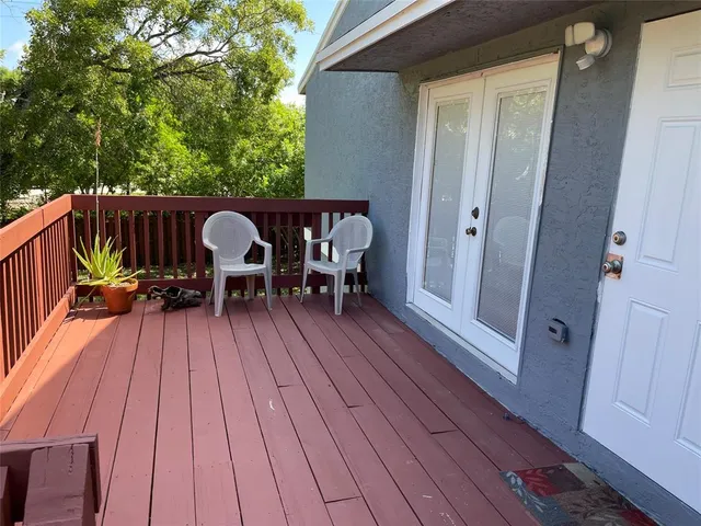 a view of deck with table and chairs and wooden floor