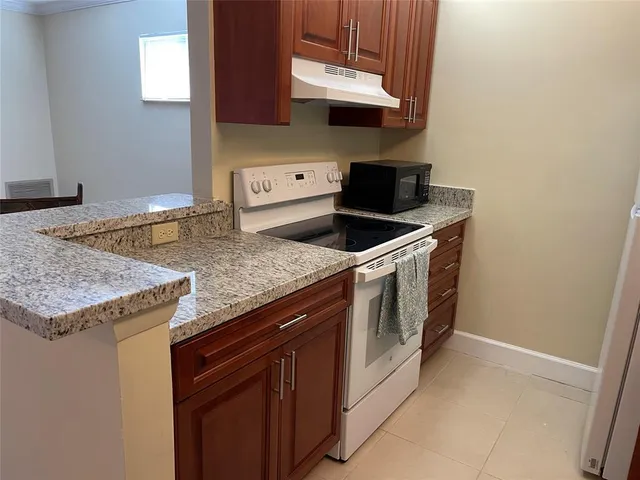 a kitchen with a sink and a stove top oven