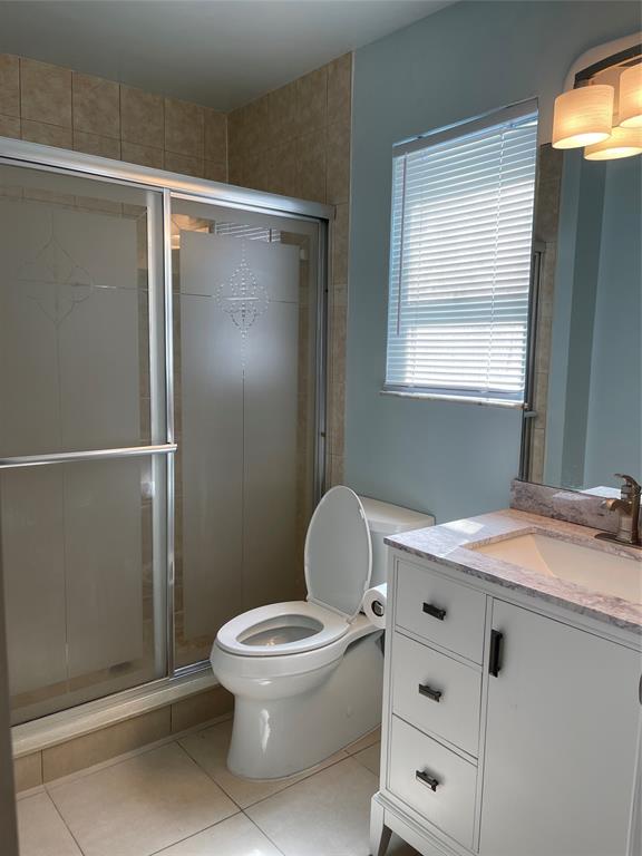 26 Crossings Circle, Unit G Boynton Beach, FL 33435 - Photo 8 of 14 a white toilet sitting next to a bathroom sink