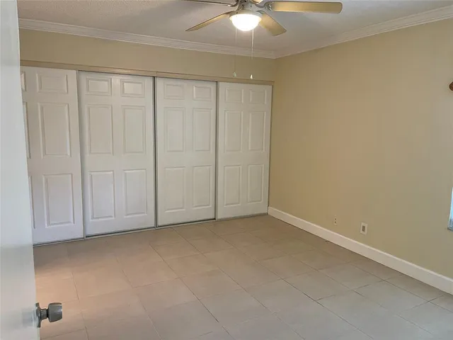 an empty room with a ceiling fan