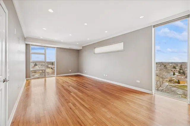 a view of empty room with wooden floor