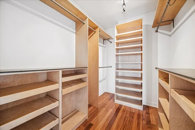 a view of walk in closet with empty racks