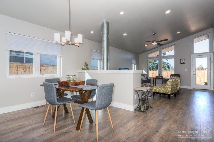 62013 Dantili Road Bend, OR 97701 - Photo 8 of 25 a dining room with wooden floor a chandelier a wooden table and chairs