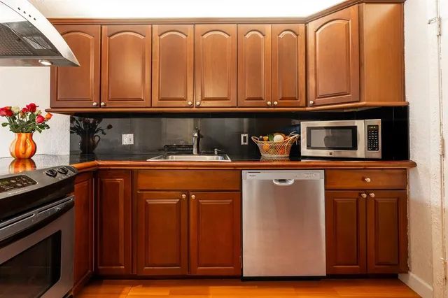 a view of a kitchen with a sink and a window