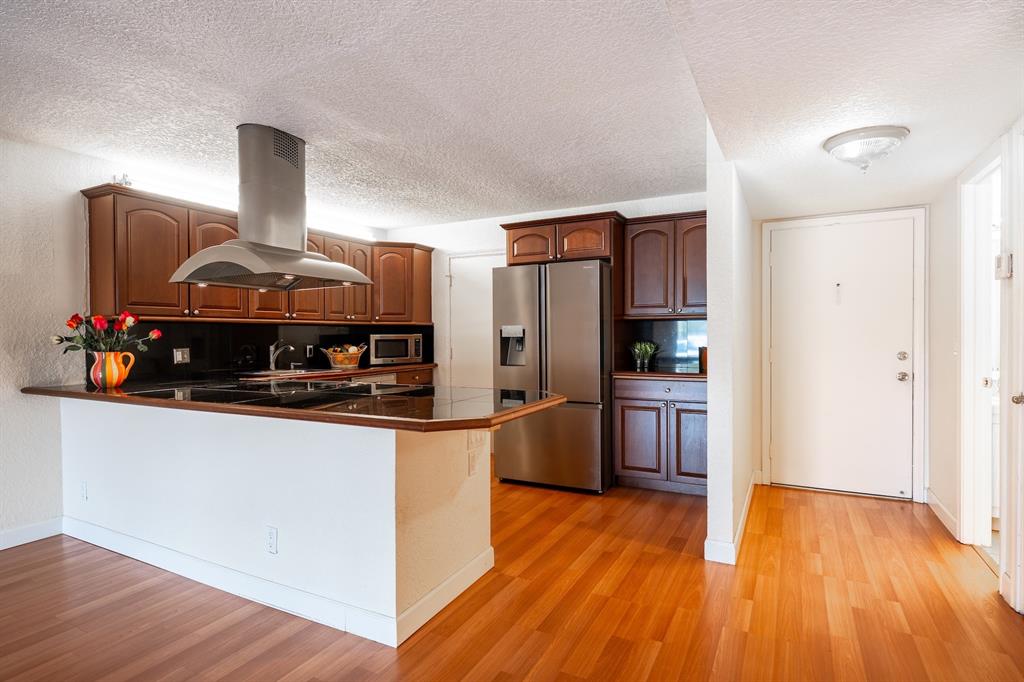 22605 Southwest 66th Avenue, Unit 102 Boca Raton, FL 33428 - Photo 19 of 27 a kitchen with stainless steel appliances granite countertop a stove and a refrigerator