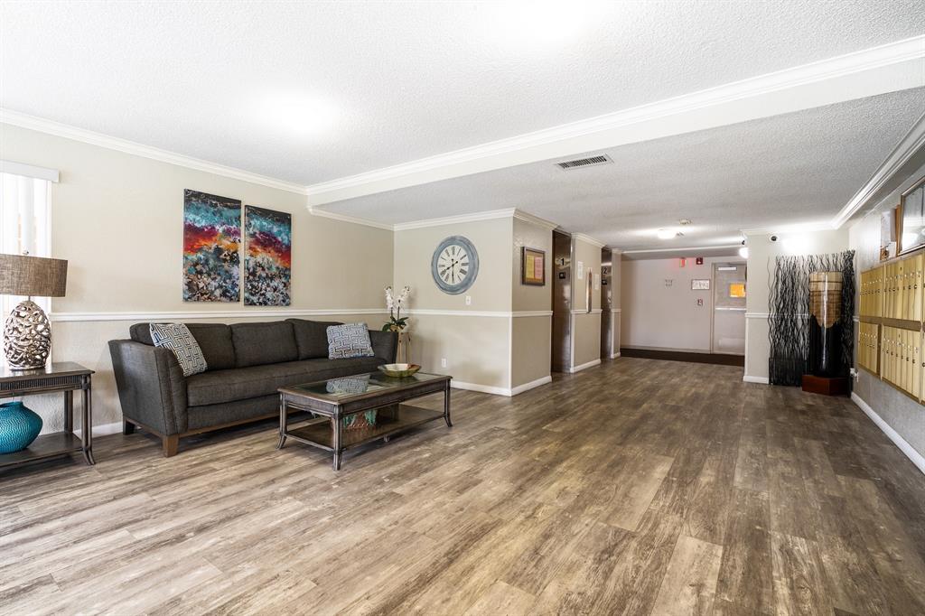 22605 Southwest 66th Avenue, Unit 102 Boca Raton, FL 33428 - Photo 23 of 27 a living room with furniture and a rug