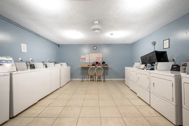 a view of a house with a backyard and sitting area