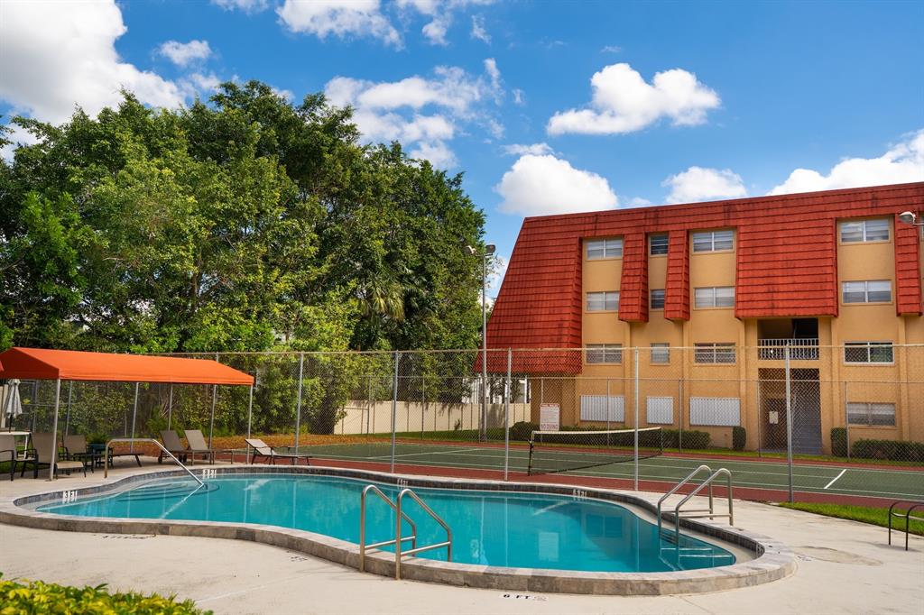 22605 Southwest 66th Avenue, Unit 102 Boca Raton, FL 33428 - Photo 25 of 27 a view of a house with a backyard and sitting area