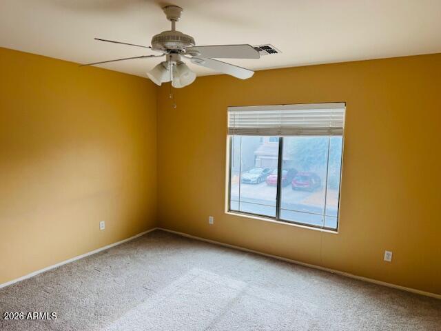 43724 West Cowpath Road Maricopa, AZ 85138 - Photo 19 of 21 an empty room with a chandelier fan and windows