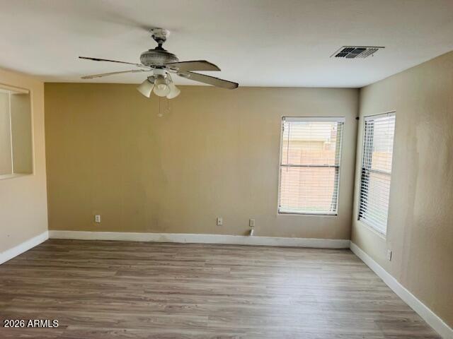 43724 West Cowpath Road Maricopa, AZ 85138 - Photo 4 of 21 wooden floor in an empty room with a window