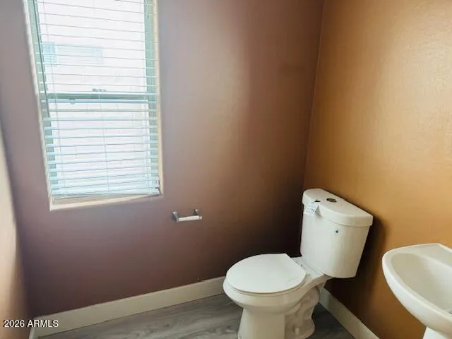 a white toilet sitting next to a bathroom sink