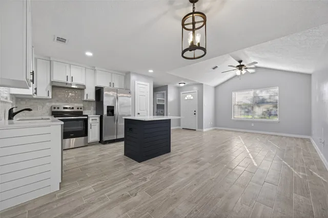 a view of kitchen with cabinets and stainless steel appliances