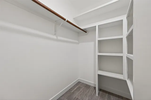a view of walk in closet with empty racks