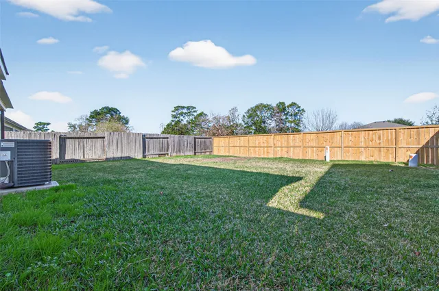 a view of green field with house in background