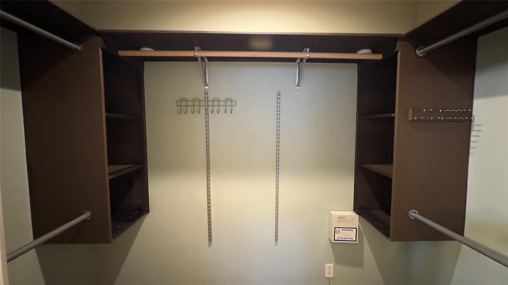 1900 Scofield Ridge Parkway, Unit 5501 Austin, TX 78727 - Photo 6 of 21 Ample storage solutions define this well-appointed closet, featuring both hanging rods and integrated shelving.