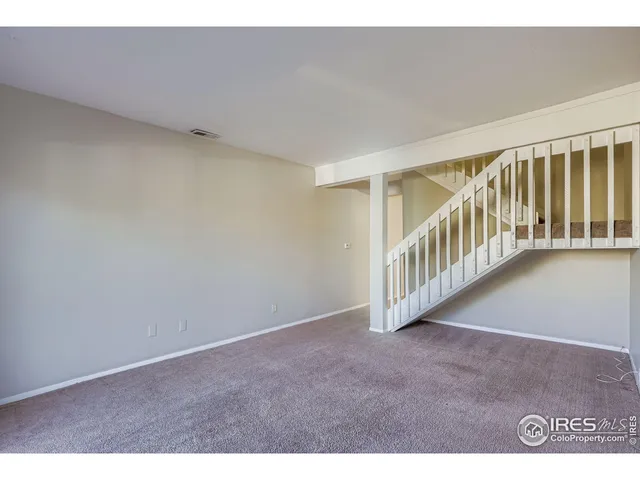 a view of an empty room with stairs