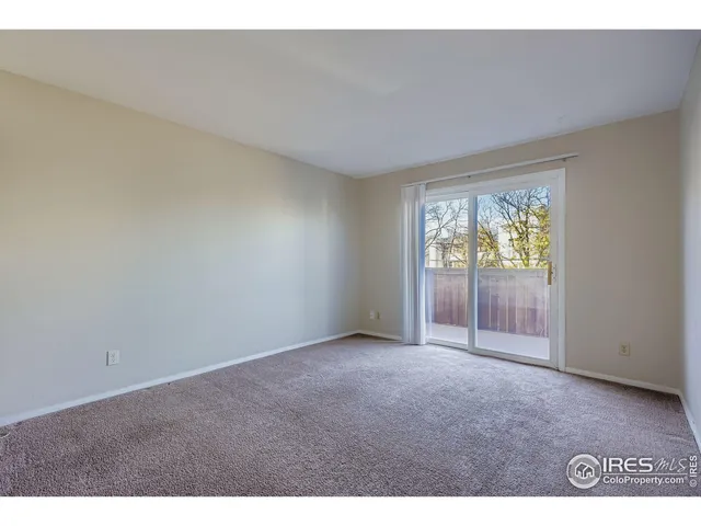 a view of an empty room with glass door