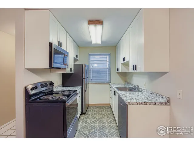 a kitchen with stainless steel appliances granite countertop a stove sink and cabinets