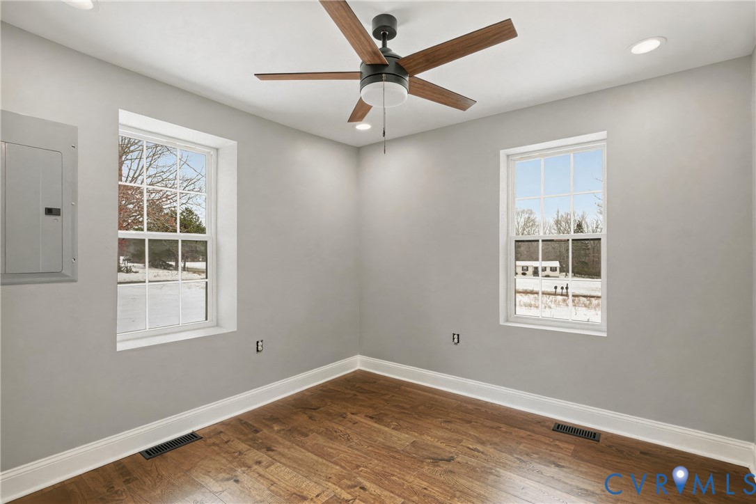 7625 Venable Road Kents Store, VA 23084 - Photo 12 of 31 a view of empty room with wooden floor and fan