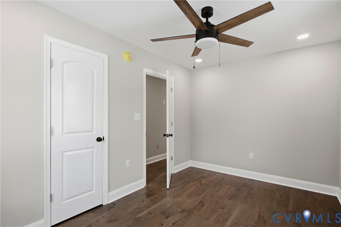 7625 Venable Road Kents Store, VA 23084 - Photo 19 of 31 an empty room with wooden floor ceiling fan and window