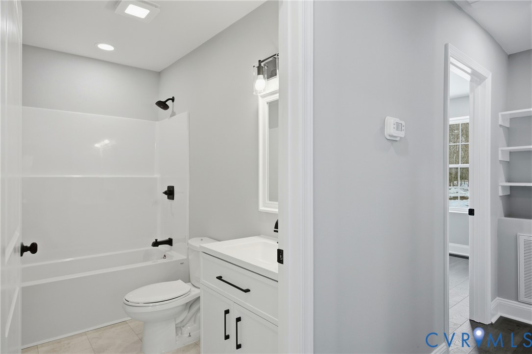 7625 Venable Road Kents Store, VA 23084 - Photo 20 of 31 a bathroom with a bathtub shower sink vanity and a toilet