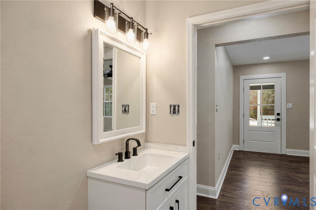 7625 Venable Road Kents Store, VA 23084 - Photo 21 of 31 a bathroom with a sink a mirror and a window