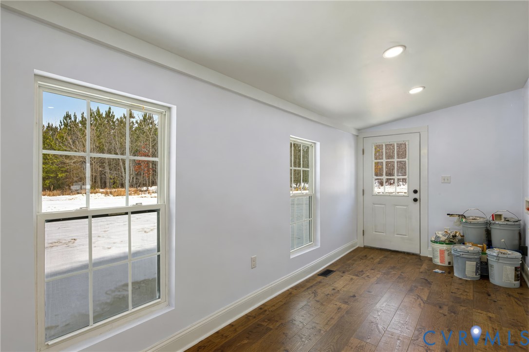 7625 Venable Road Kents Store, VA 23084 - Photo 24 of 31 an empty room with wooden floor and windows