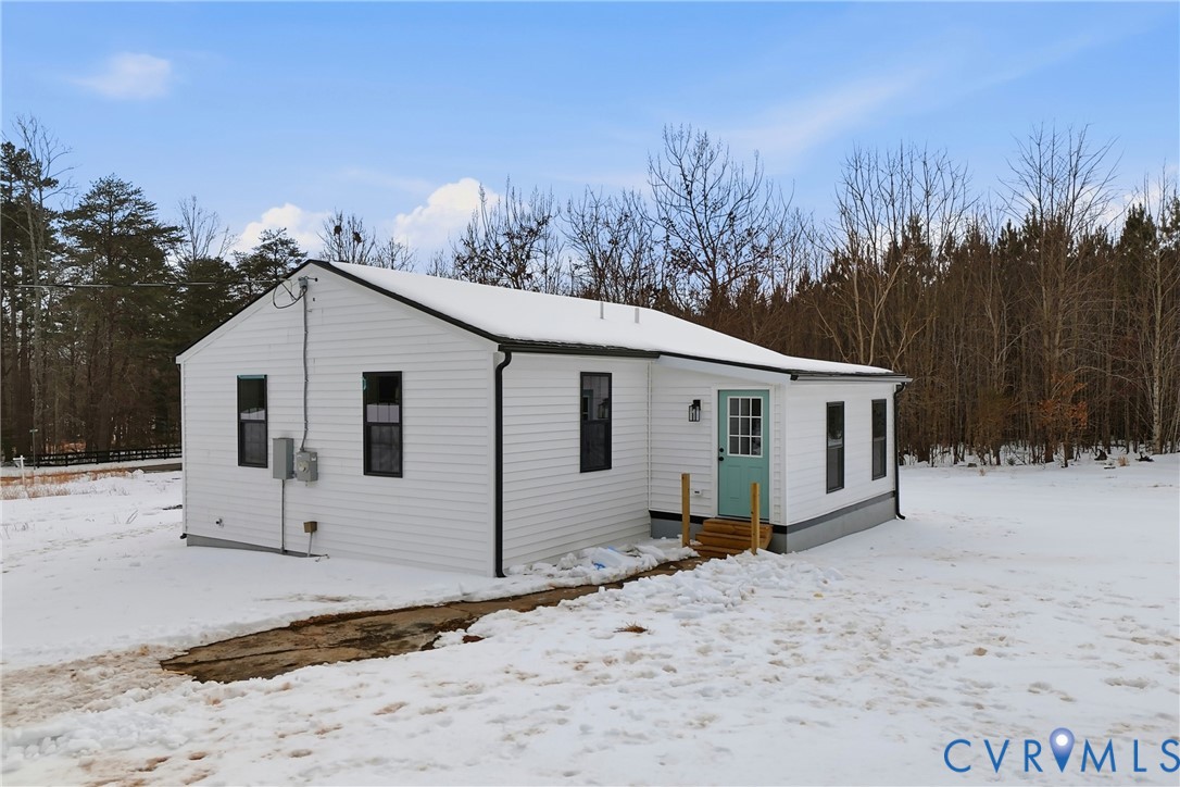 7625 Venable Road Kents Store, VA 23084 - Photo 25 of 31 a view of a white house with a yard covered in snow