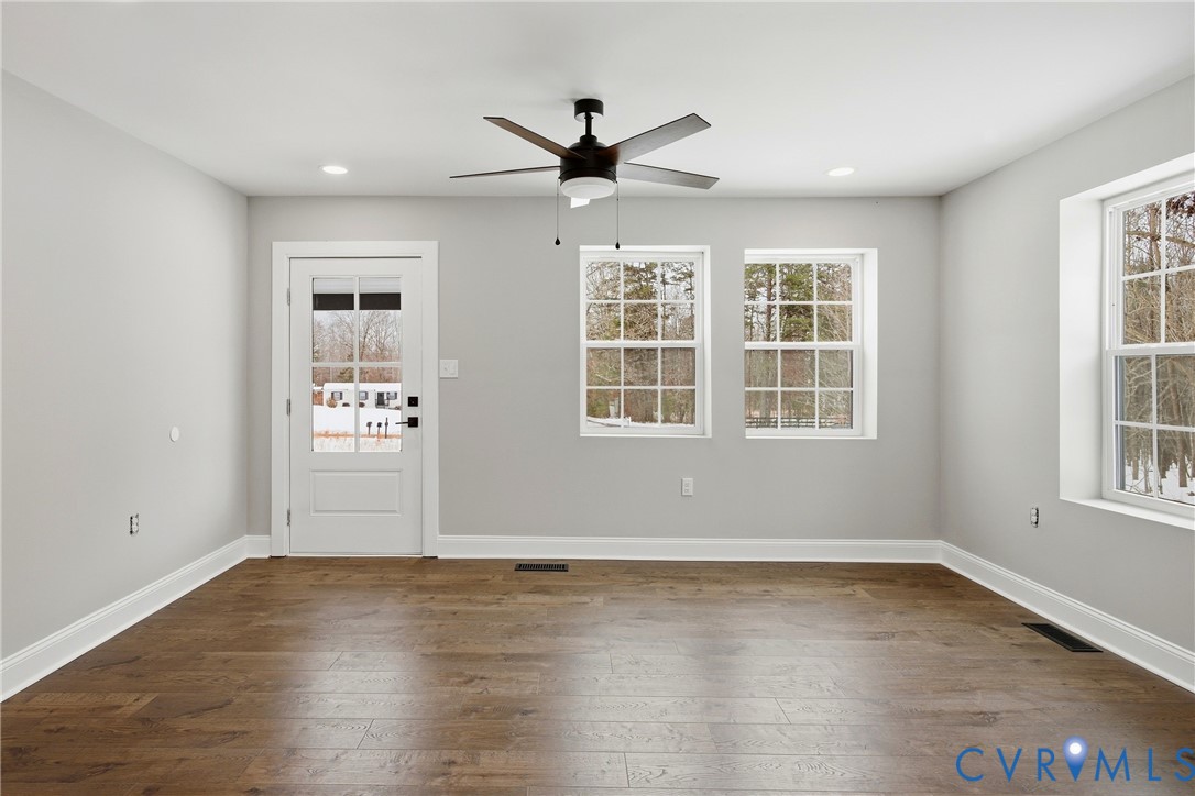 7625 Venable Road Kents Store, VA 23084 - Photo 3 of 31 an empty room with wooden floor and windows