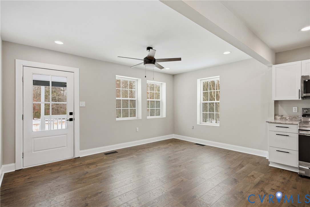 7625 Venable Road Kents Store, VA 23084 - Photo 4 of 31 a view of an empty room with a window and wooden floor