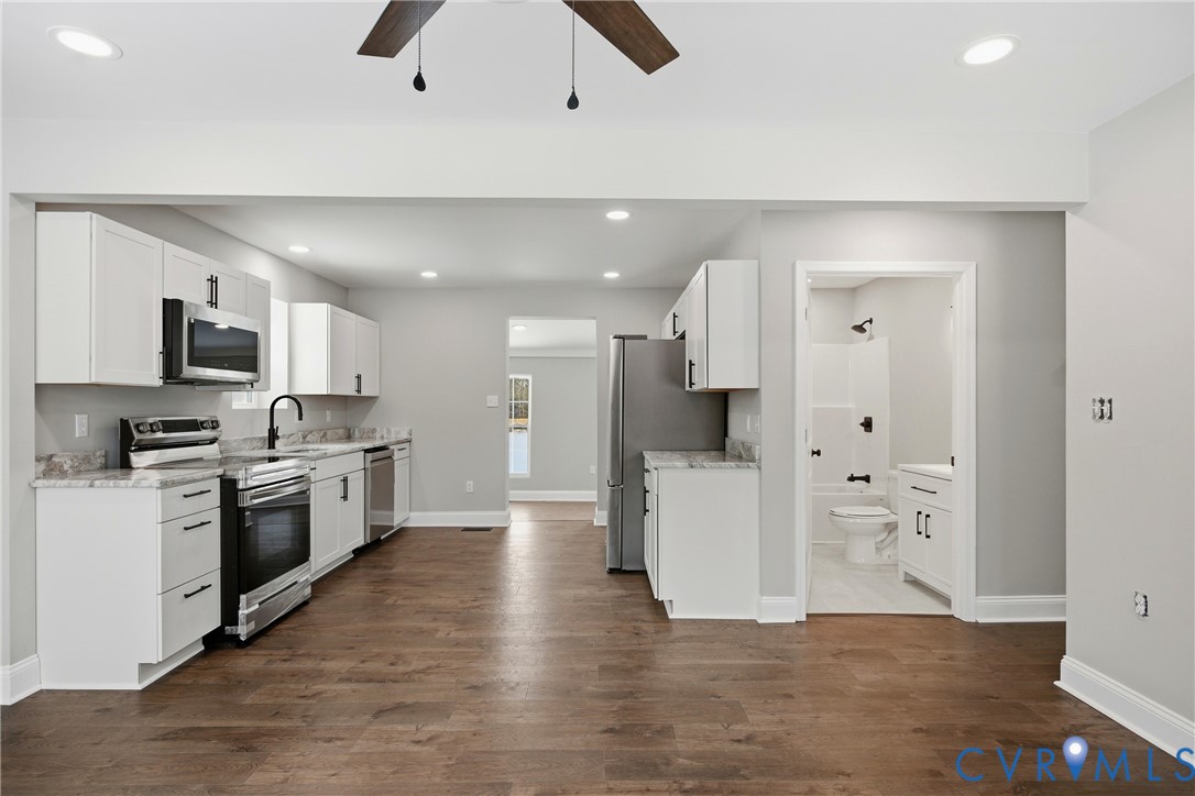 7625 Venable Road Kents Store, VA 23084 - Photo 6 of 31 a large kitchen with white cabinets and stainless steel appliances