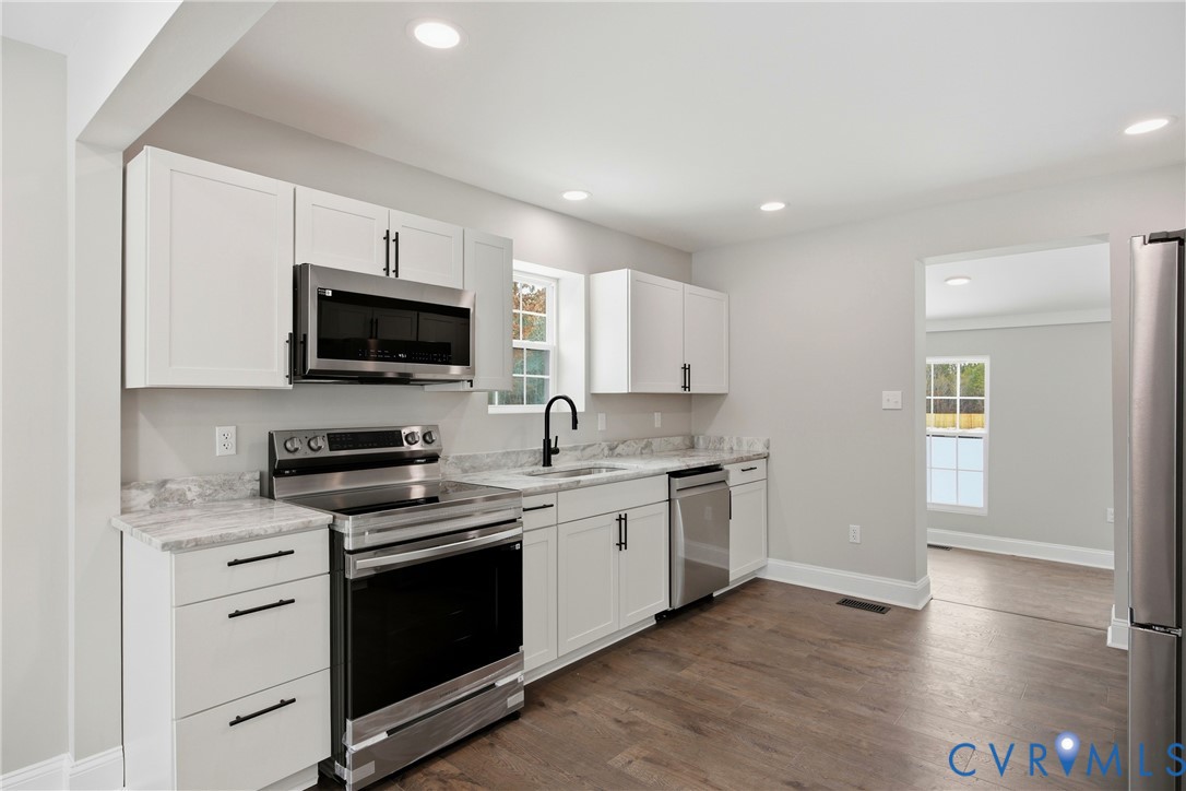 7625 Venable Road Kents Store, VA 23084 - Photo 7 of 31 a kitchen with stainless steel appliances a stove microwave and sink