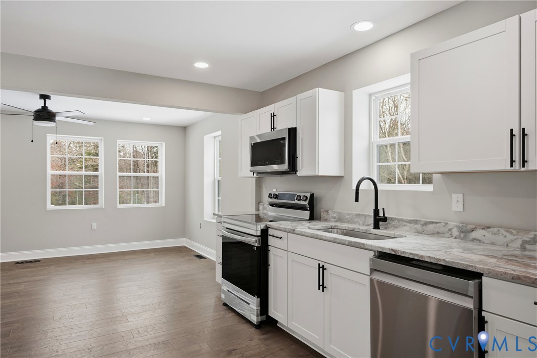 7625 Venable Road Kents Store, VA 23084 - Photo 10 of 31 a kitchen with granite countertop a sink and a stove top oven