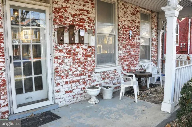 a view of a patio with table and chairs and potted plants